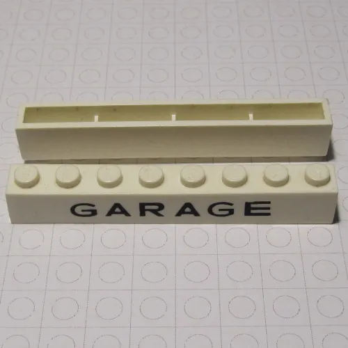 Brick 1 x 8 without Bottom Tubes with Cross Side Supports with 'GARAGE' Medium Sans-Serif Black Print