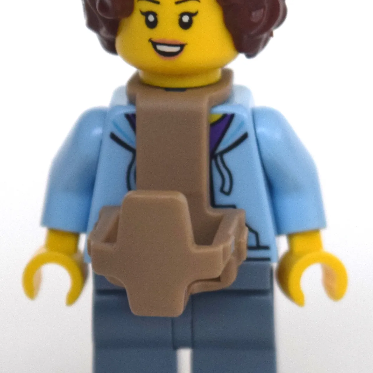 Woman, Open Jacket over Purple Shirt, Sand Blue Legs, Baby Carrier, Reddish Brown Hair