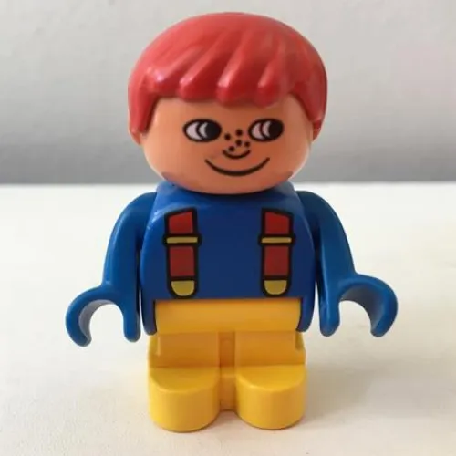 Duplo Figure, Early with Joined Legs Yellow, Blue Top with Red Suspenders, Red Hair, Freckles, White in Eyes Print