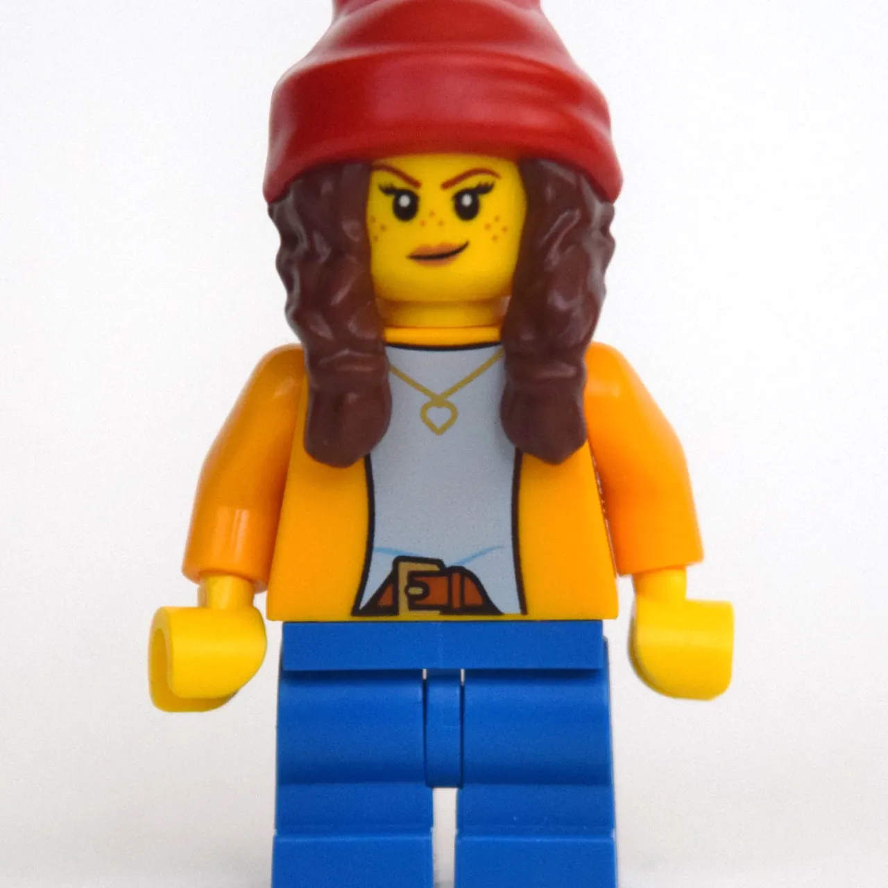 Girl, Bright Light Orange Shirt, Blue Medium Legs, Red Beanie with Braids